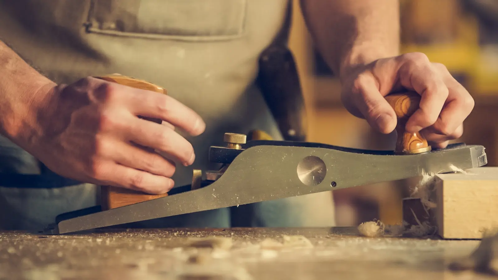 Un charpentier au travail sur une pièce de bois
